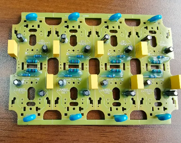 Capacitors and resistors are located around the V-groove of the power supply product